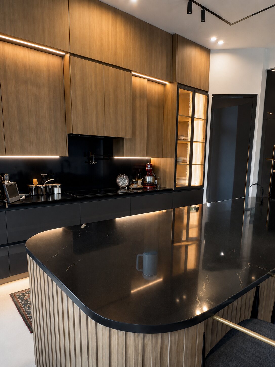 Modern black and wood custom kitchen with curved island